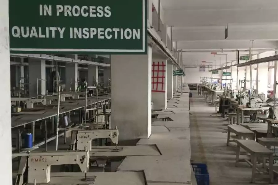 A sign is seen as a building safety assessment is being conducted at an Adorn Knitwear garments factory in Dhaka, December 9, ...sewing machines gathering dust as the lengthy process of checking the building for structural weakness was underway (Reuters).