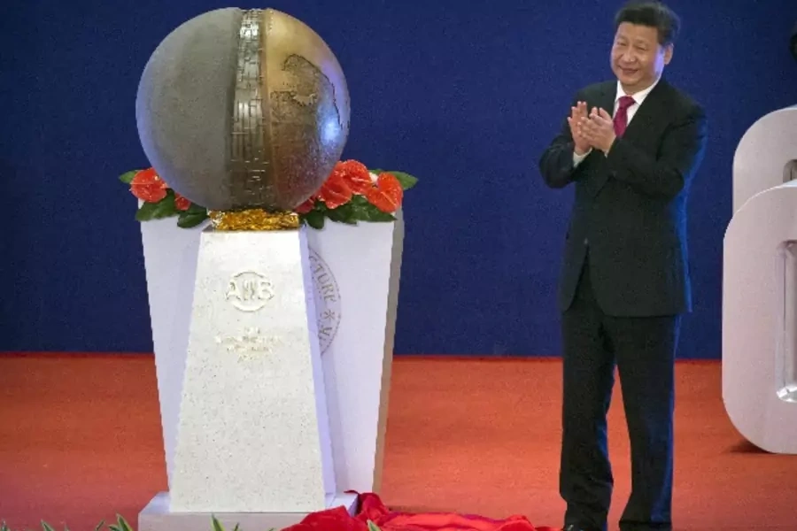 Chinese President Xi Jinping applauds after unveiling a sculpture during the opening ceremony of the Asian Infrastructure Investment Bank (AIIB) in Beijing, China, January 16, 2016. (Mark Schiefelbein/Reuters)