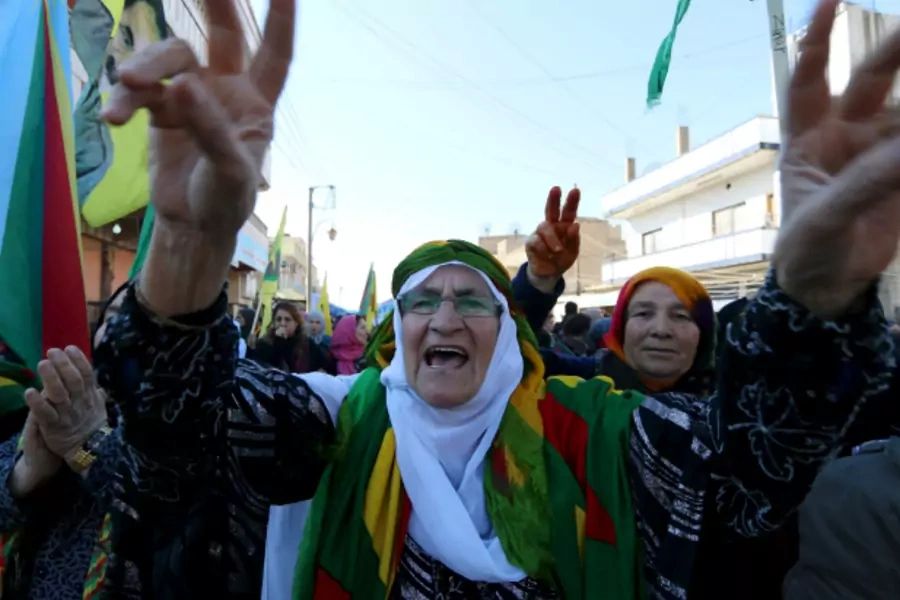 Kurdish women gesture and shout slogans during a demonstration against the exclusion of the Syrian Kurds from the Geneva talks, in the northeast Syrian Kurdish city of Qamishli (Rodi Said/Reuters).