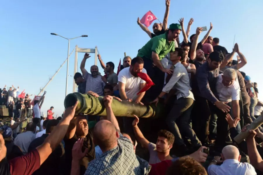 Supporters of Turkish President Tayyip Erdogan celebrate after soldiers involved in the coup surrendered on the Bosphorus Bridge in Istanbul (Yagiz Karahan/Reuters).