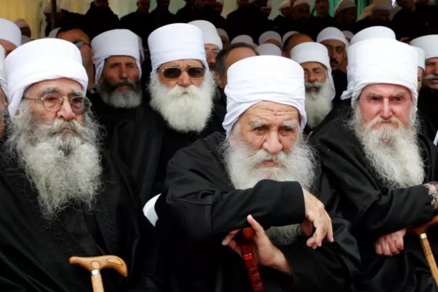 Druze clerics attend the funeral ceremony of top Druze cleric Sheikh Ahmed Salman al-Hajri in al-Suwayda city (Khaled al-Hariri/Reuters).