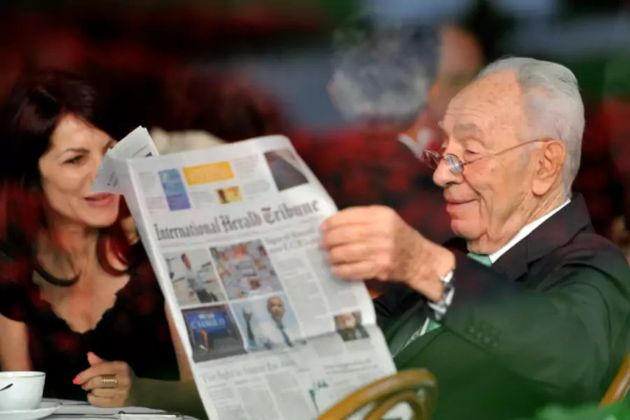 Israeli President Shimon Peres reads a newspaper during the Ambrosetti workshop in Cernobbio, next to Como (Paolo Bona/Reuters).
