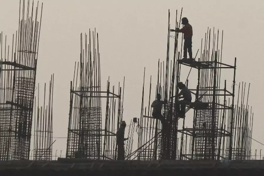 Labourers work at the site of a commercial building under construction in Noida, on the outskirts of New Delhi December 13, 20... and increasingly getting – rapid increases in pay and benefits. Picture taken December 13, 2013. REUTERS/Anindito Mukherjee