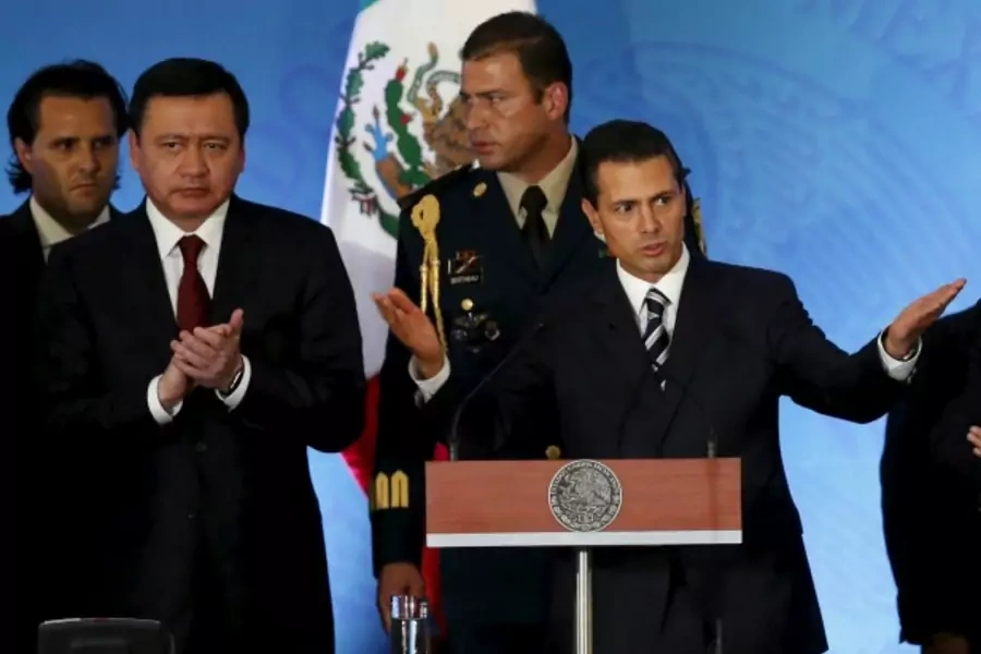 Mexico's President Enrique Pena Nieto (R) gestures as Mexico's Interior Minister Miguel Angel Osorio Chong applauds during the...om public contractors, but opposition lawmakers poured scorn over the bid to lay the scandal to rest (Reuters/Edgard Garrido).
