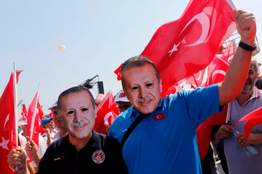 People wear masks depicting Turkish President Tayyip Erdogan during the Democracy and Martyrs Rally (Umit Bektas/Reuters).