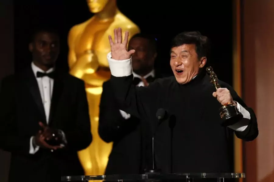 Actor Jackie Chan reacts as he accepts his honorary award as actor Chris Tucker (C) looks on at the 8th Annual Governors Awards in Los Angeles, California on U.S., November 12, 2016. 