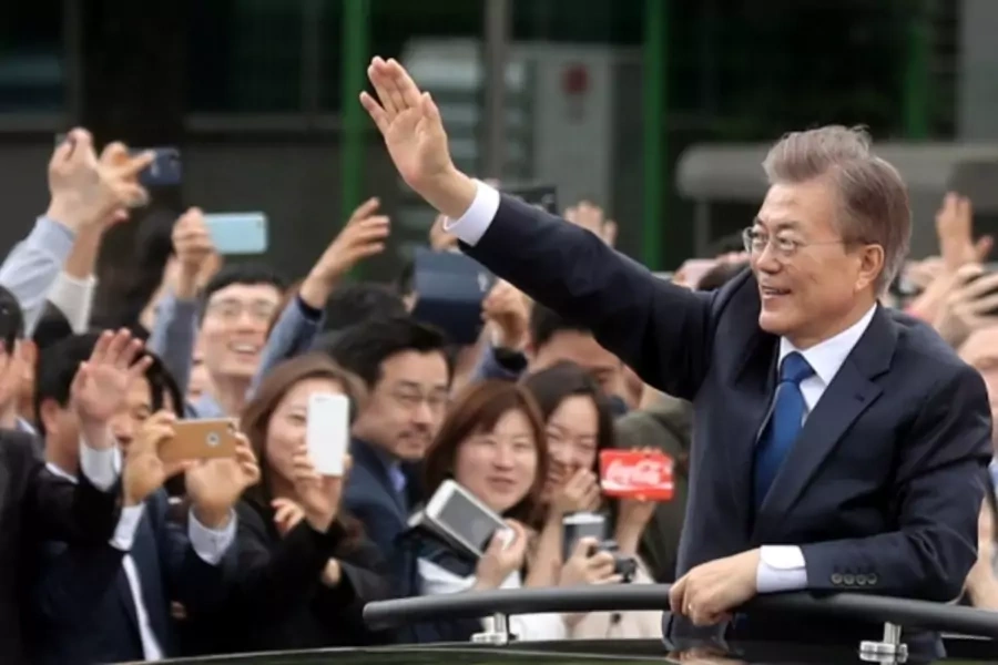 South Korean President Moon Jae-in waves in a car as he heads to the presidential Blue House after his inaugural ceremony in Seoul, South Korea, May 10, 2017.