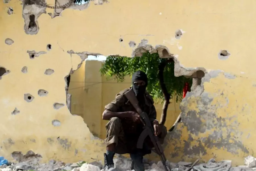 A Somali soldier takes position at the scene of a suicide attack by al-Shabaab militants in capital Mogadishu June 21, 2015. 