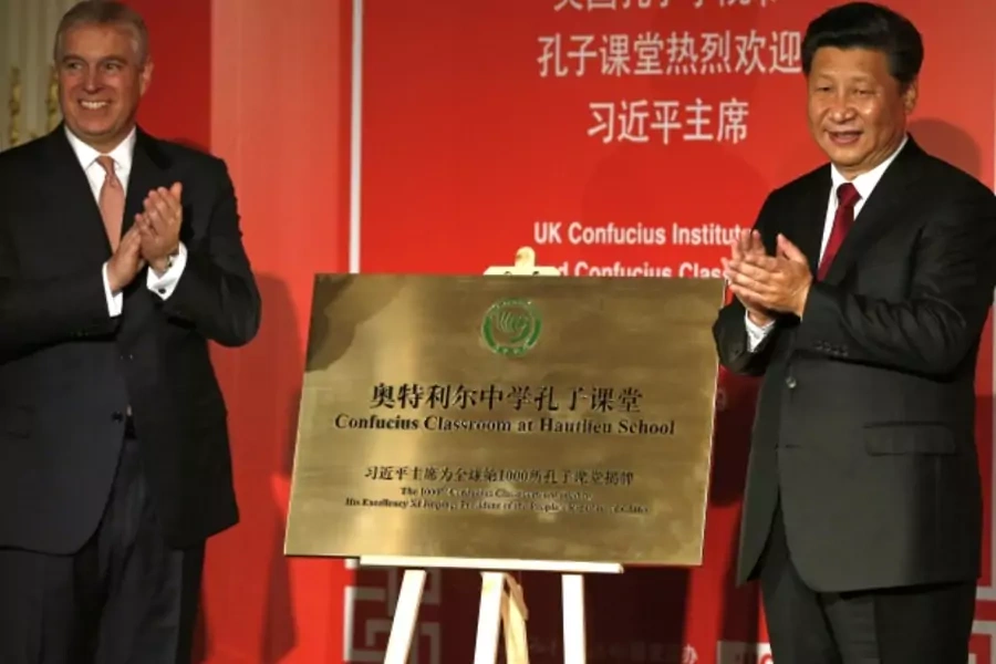 China's President Xi Jinping (R) applauds with Britain's Prince Andrew after unveiling a plaque during a Confucius event at the Mandarin Oriental hotel in London, October 22, 2015.