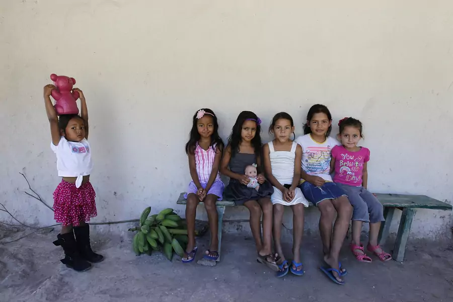 Girls pose for a picture at the small village of Suyatal, outskirts of Tegucigalpa June 25, 2014.
