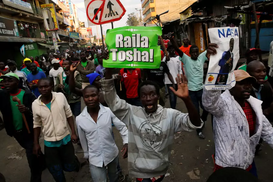 Supporters of Kenyan opposition leader Raila Odinga carry banners as they walk along a street in Humura neighborhood, in Nairobi, Kenya August 10, 2017.