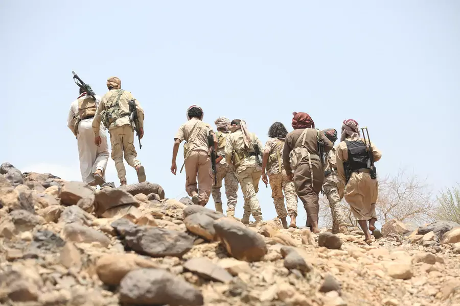 Soldiers and members of the Popular Resistance militiamen backing Yemen's President Abd-Rabbu Mansour Hadi walk as they head to the frontline of fighting against forces of Houthi rebels in Makhdara area of Marib province, Yemen (Ali Owidha/Reuters).