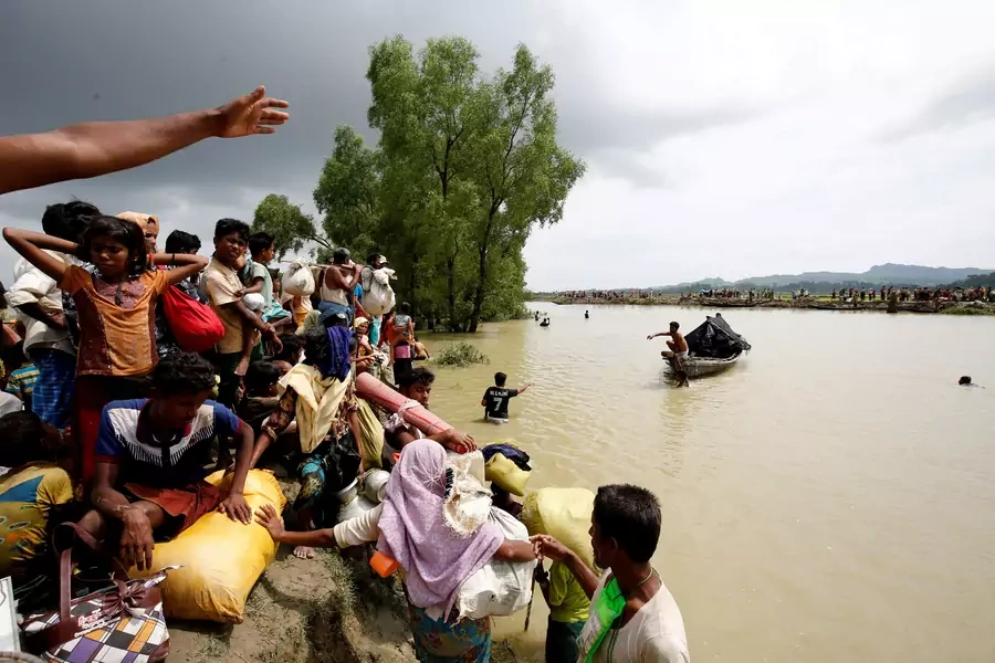 Rohingya refugees wait for boat to cross a canal after crossing the border through the Naf river in Teknaf, Bangladesh, on September 7, 2017.
