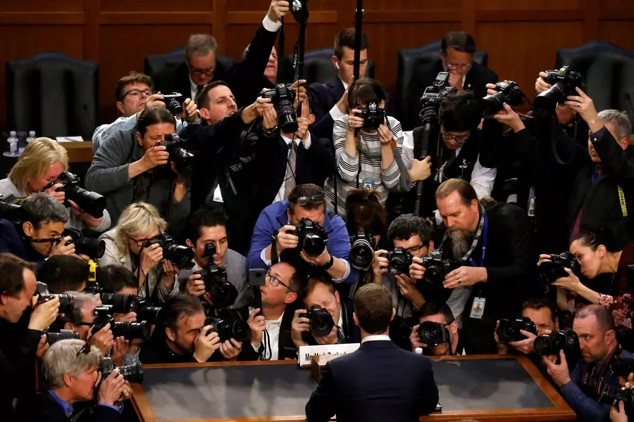 Facebook CEO Mark Zuckerberg is surrounded by members of the media as he arrives to testify before a joint meeting of the Senate Judiciary and Commerce Committees