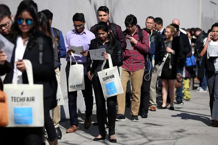 People wait in line to attend TechFair LA, a technology job fair, in Los Angeles, California, on January 26, 2017. 