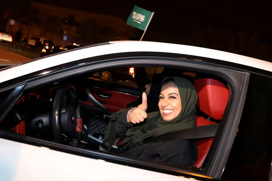 A Saudi woman celebrates as she drives her car in her neighborhood, in Al Khobar, Saudi Arabia, June 24, 2018. 