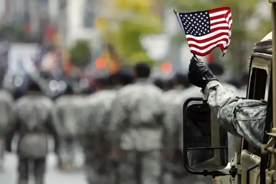 U.S. Army serviceman waves an American flag during a Veterans Day parade in New York. 