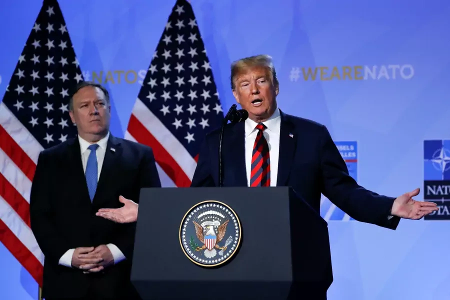 Acting U.S. Secretary of State Mike Pompeo looks on as U.S. President Donald Trump holds a news conference after participating in the NATO Summit in Brussels, Belgium July 12, 2018. 