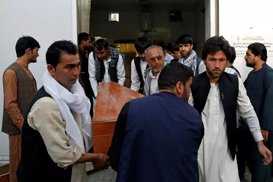 Relatives carry coffin of a victim of a blast in Kabul, Afghanistan, on July 15, 2018. 