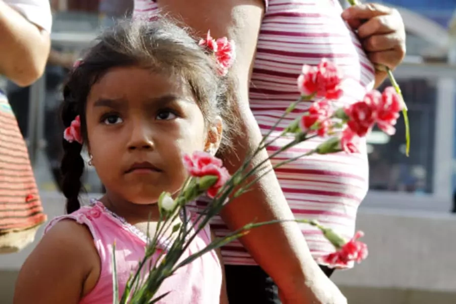 A child holding flowers during International Women's Day in Lima, March 8, 2011.