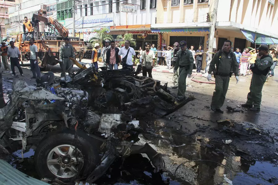Thai security personnel inspect a remains of a pick-up truck, at the site of a bomb attack in southern Thailand's Narathiwat province on July 20, 2012. 