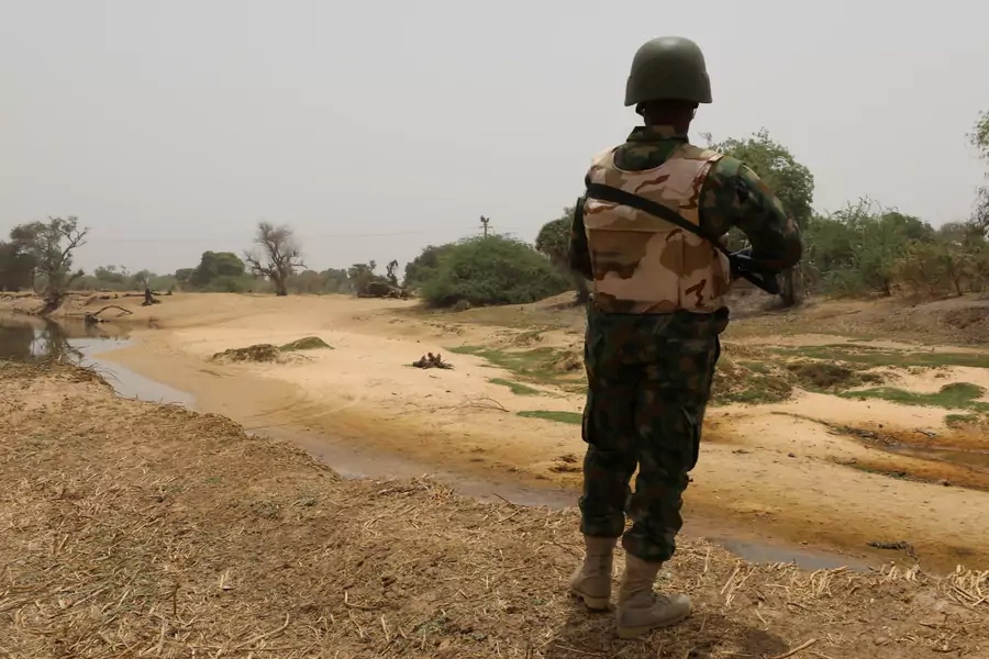 A Nigerian soldier stands watching the border with Niger at Damasak, Borno, Nigeria on April 25, 2017. 