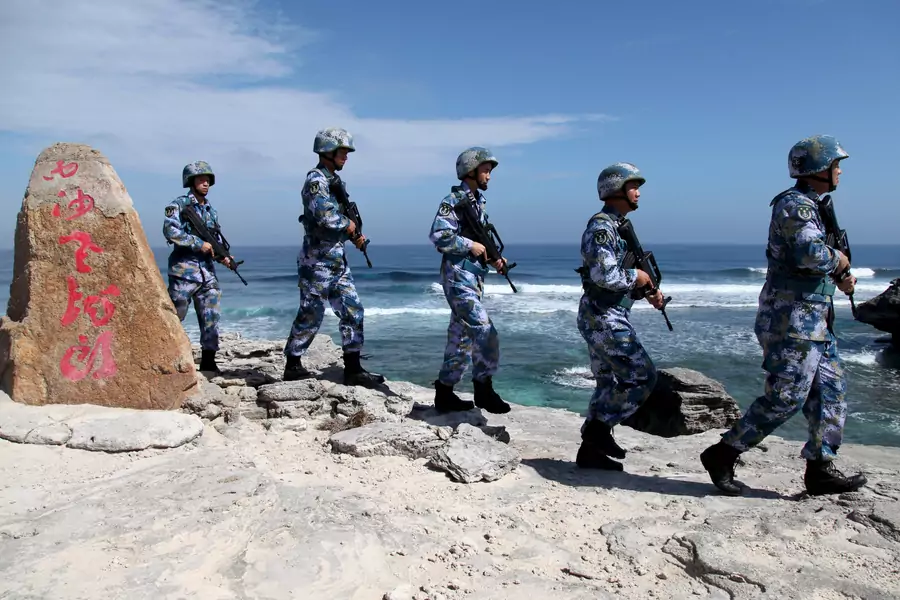 Members of China's People's Liberation Army Navy patrol at Woody Island in the Paracel Archipelago in January 2016.