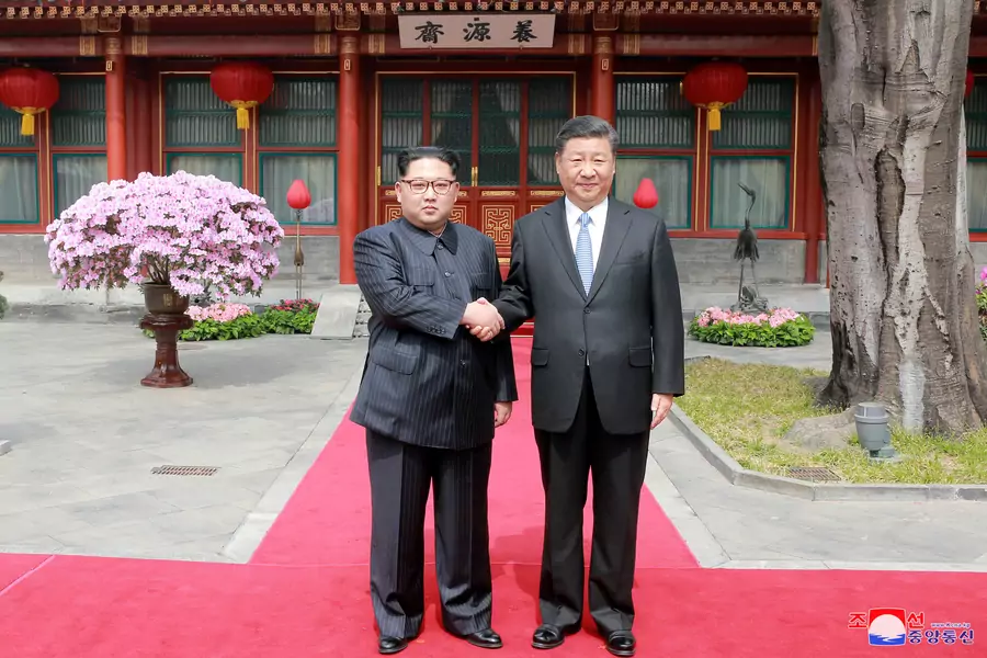North Korean leader Kim Jong-un shakes hands with Chinese President Xi Jinping in Beijing, as he paid an unofficial visit to China, in this undated photo released by North Korea's Korean Central News Agency (KCNA) on March 28, 2018.