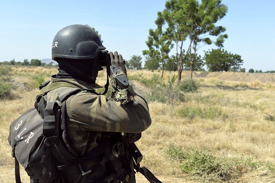 A Cameroonian soldier looks at the border through binoculars on November 12, 2014, in Amchide, northern Cameroon, one kilometer from Nigeria.