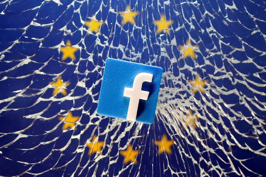 A Facebook logo is placed on broken glass above a printed EU flag in this illustration taken January 28, 2019. 