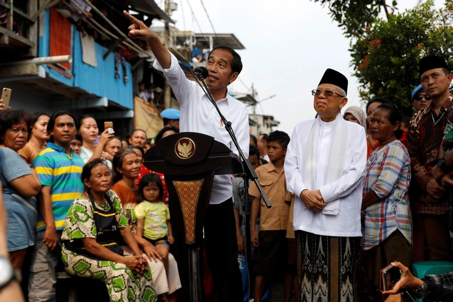 Indonesia's Incumbent President Joko Widodo gestures next to his running mate Ma'ruf Amin as they make a public address following the announcement of the last month's presidential election results at a rural area of Jakarta, Indonesia, on May 21, 2019.