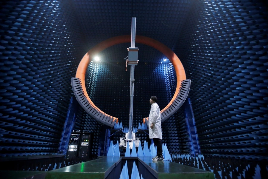 An engineer stands under a base station antenna in Huawei's SG178 multi-probe spherical near-field testing system at its Songshan Lake Manufacturing Center in Dongguan, China, on May 30, 2019.