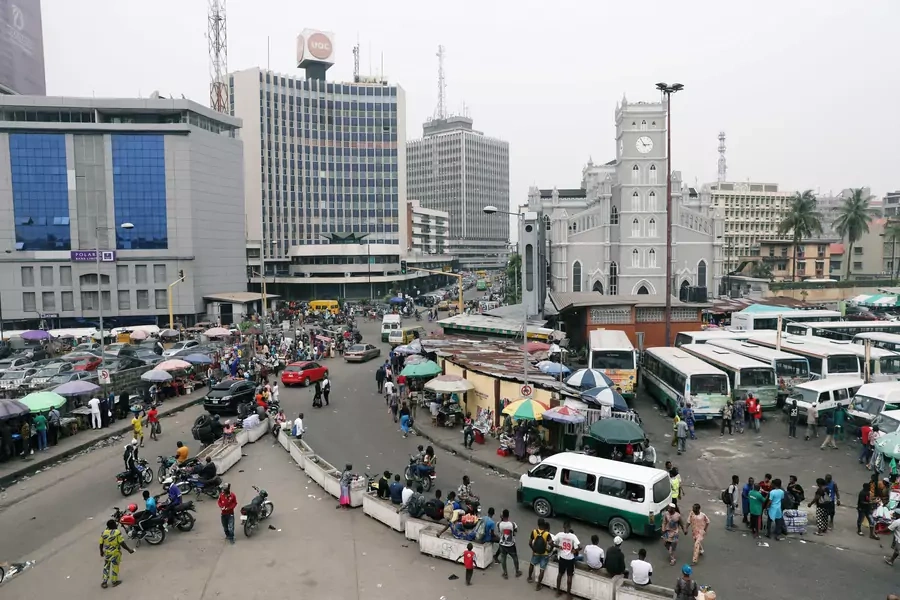 People move on a street of Marina in Victoria Island, Lagos, Nigeria, on February 15, 2019.