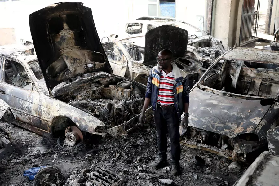 Nigerian entrepreneur Basil Onibo, one of the victims of the latest spate of xenophobic attacks, looks at the burnt out cars at his dealership in Johannesburg, South Africa, on September 5, 2019.