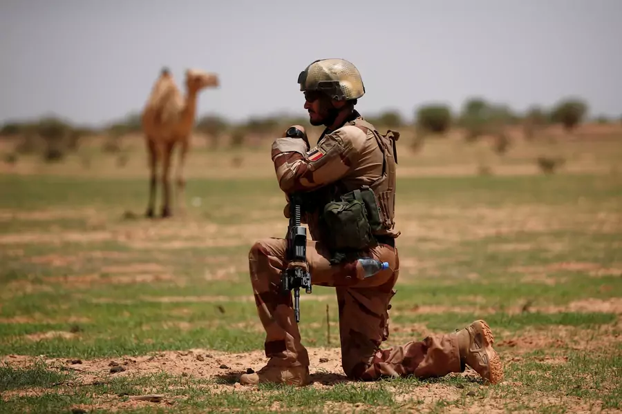 A French soldier of the "Belleface" Desert Tactical Group (GTD) conducts an area control operation in the Gourma region during Operation Barkhane in Ndaki, Mali, on July 27, 2019. 