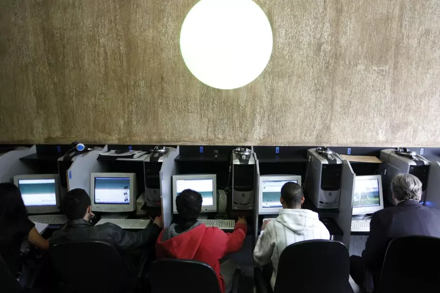 Customers use computers at an internet cafe in Sao Paulo.