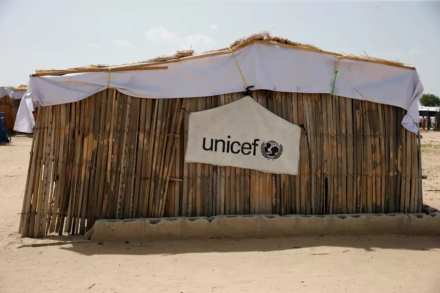 A banner with the UNICEF logo is seen hanging on a makeshift school at an internally displaced persons camp on the outskirts of Maiduguri, northeast Nigeria, on June 6, 2017.