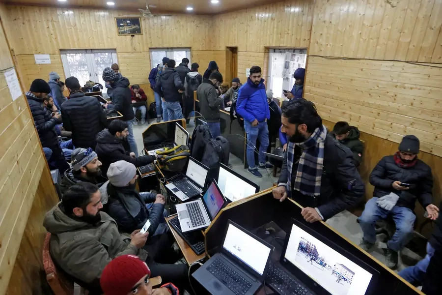 Journalists use the internet as they work inside a government-run media centre in Srinagar