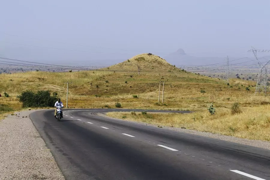 A man rides his motorbike along Gombe Numan highway in Gombe state, on November 29, 2013.