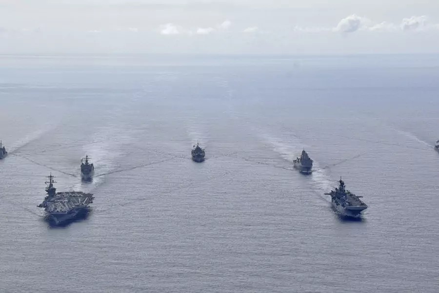 U.S. Navy ships from the Theodore Roosevelt Carrier Strike Group, the America Expeditionary Strike Group, and the U.S. 7th Fleet command ship, USS Blue Ridge, transit the Philippine Sea in formation during a photo exercise on March 24, 2020.