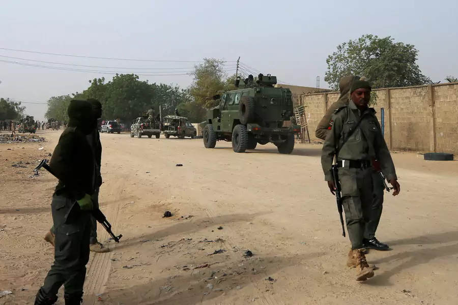 Nigerian military personnel, pictured here on February 16, 2019, securing an area after a man was killed by suspected militants in Maiduguri, have been stretched thin, and are deployed in almost every Nigerian state. 