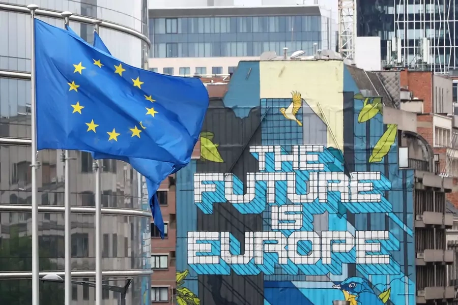 European Union flags flutter outside the European Commission headquarters.