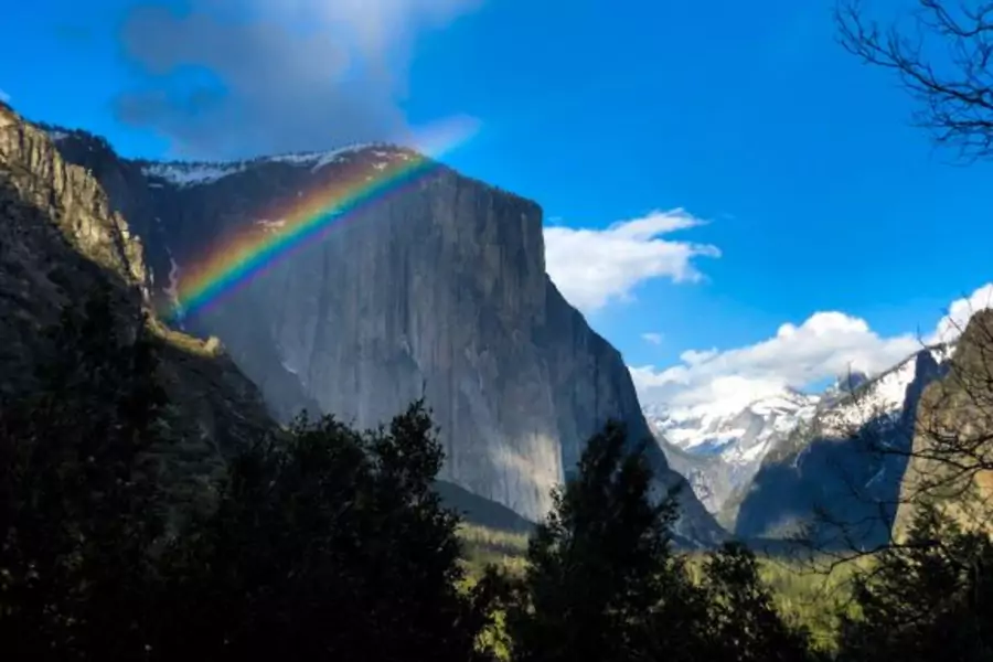A rainbow is seen across the Yosemite Valley in front of El Capitan granite rock formation in Yosemite National Park in California, on March 29, 2019. 