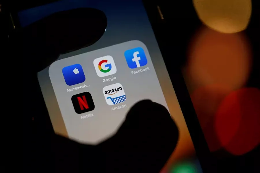 The logos of mobile apps, Google, Amazon, Facebook, Apple and Netflix, are displayed on a screen in this illustration picture taken December 3, 2019.