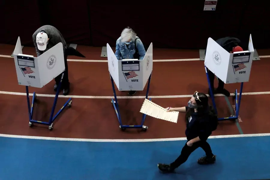 Voters fill out their ballots during early voting in New York City on October 27, 2020. 