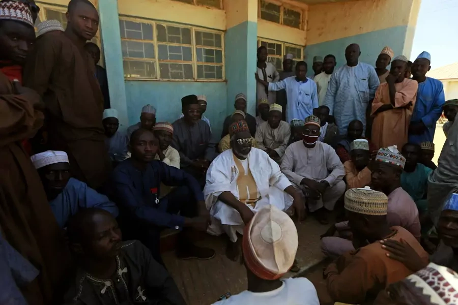 Parents gather during a meeting at the Government Science school after gunmen abducted students from it, in Kankara, in northwestern Katsina state, Nigeria on December 13, 2020.