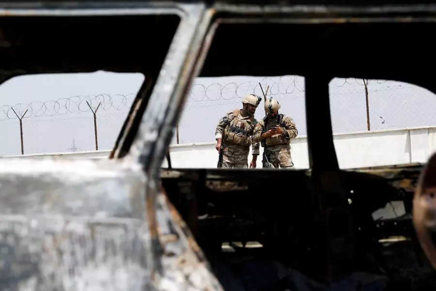 Afghan police officers inspect a vehicle from which insurgents fired rockets, in Kabul, Afghanistan, on August 18, 2020.