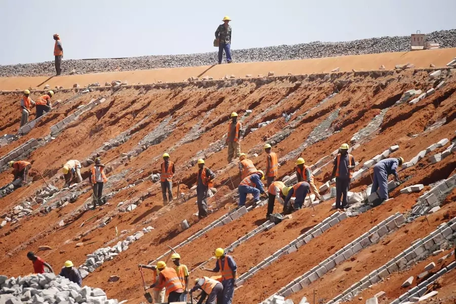 Construction workers work on the new standard gauge railway line near Voi town, Kenya on March 16, 2016.