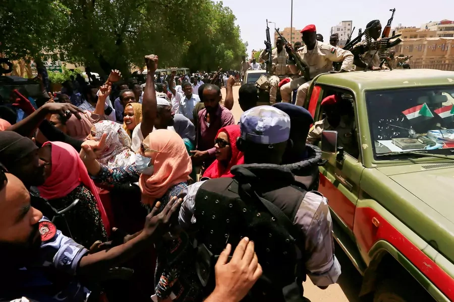 Sudanese citizens attempt to cross a police blockade as they chant slogans outside a court during the trial against ousted President Omar al-Bashir and his former allies on charges of leading a 1989 military coup in Khartoum, Sudan on September 1, 2020.