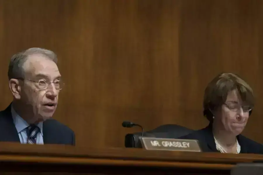 Senators Grassley (R-IA), left, and Klobuchar (D-MN), right, in a committee hearing.